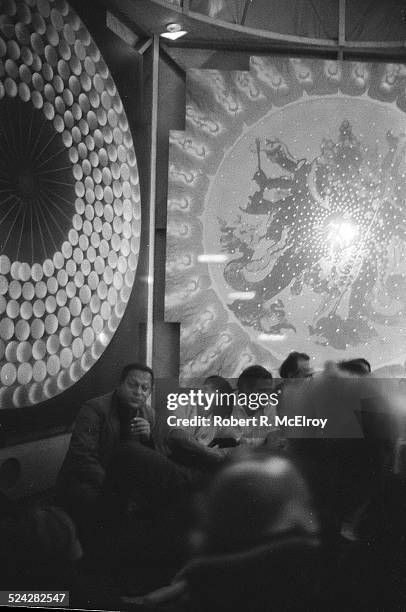 Filmmaker Agnes Varda, center, among a group of staff, members, and attendees of the New York Film Festival, looks up at imagery on the wall, during...
