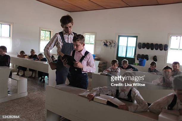 Mennonite Students from camp 2 in the colony of Manitoba, Bolivia, learning the German alphabet at school. Boys attend school from the ages 6 to 12...