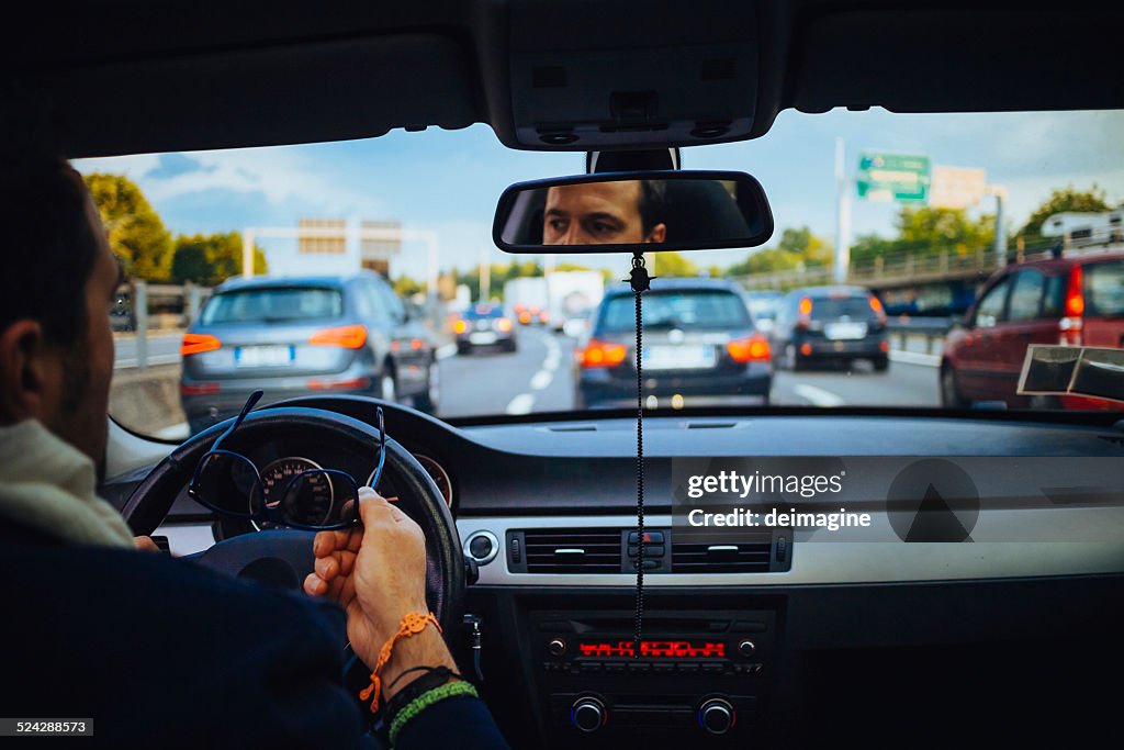 Mann im Auto während der Verkehr auf der Autobahn
