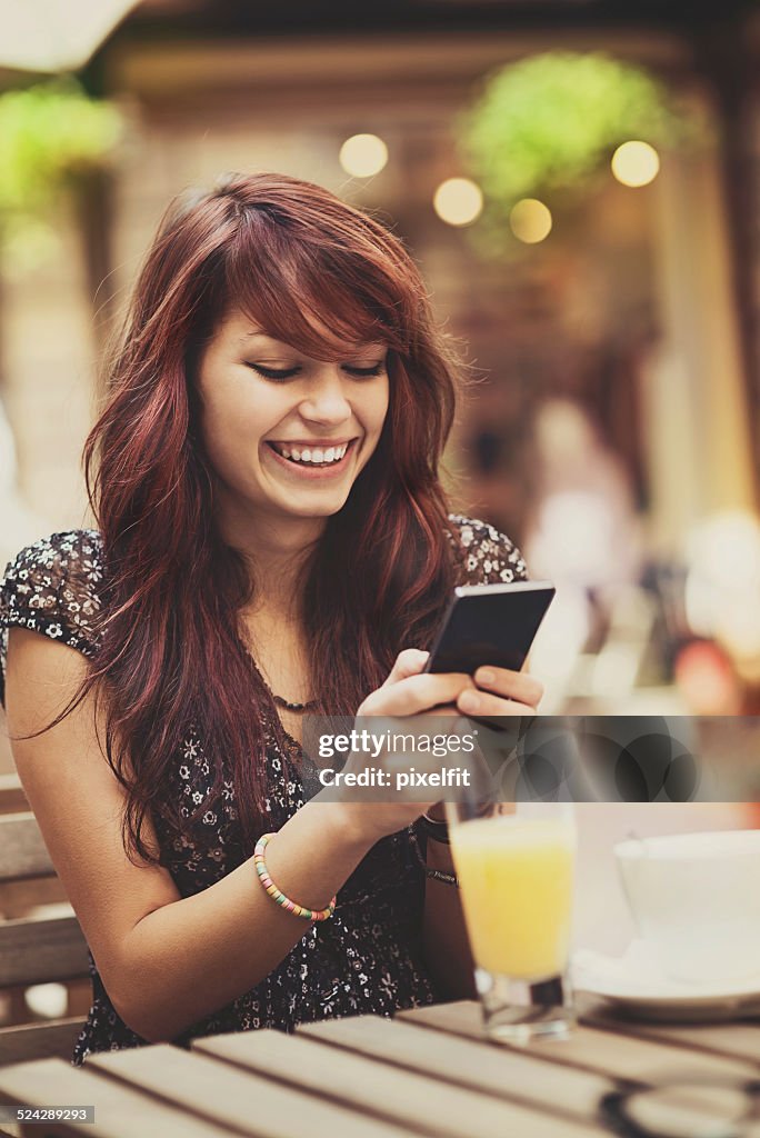 Young woman with smart phone texting