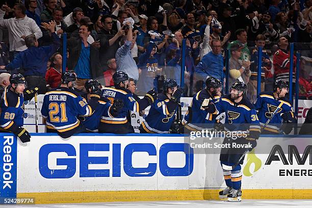 Troy Brouwer of the St. Louis Blues is congratulated by teammates after scoring the game winning goal against the Chicago Blackhawks in Game Seven of...