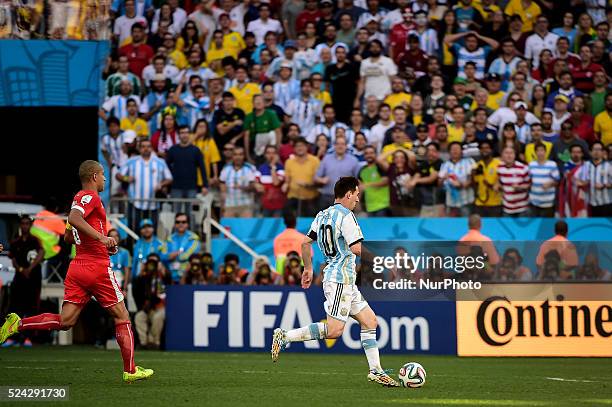 Lionel Messi carries the ball trough the midfiel to pass to Angel Di Maria socre for Argentina, at the extra Time of the match, for the Round of 16...