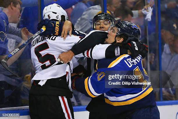 Linesman Jay Sharrers breaks up a fight between David Rundblad of the Chicago Blackhawks and Scottie Upshall of the St. Louis Blues in Game Seven of...