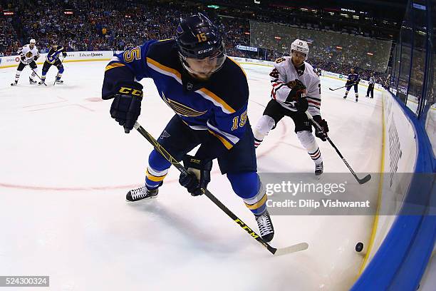 Robby Fabbri of the St. Louis Blues passes the puck against Marcus Kruger of the Chicago Blackhawks in Game Seven of the Western Conference First...