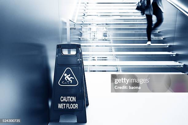 wet floor caution - val stockfoto's en -beelden