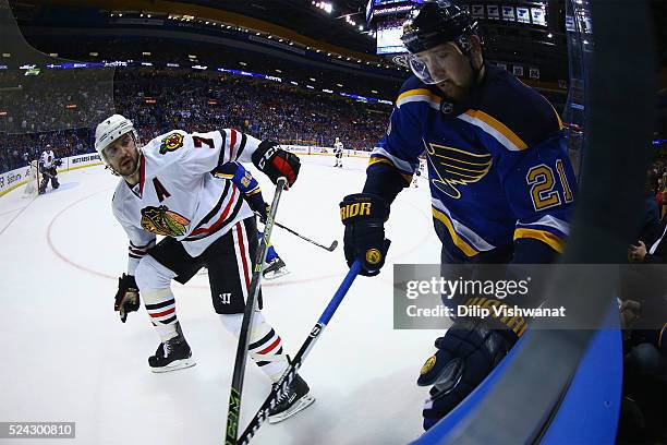 Patrik Berglund of the St. Louis Blues beats Brent Seabrook of the Chicago Blackhawks to the puck in Game Seven of the Western Conference First Round...