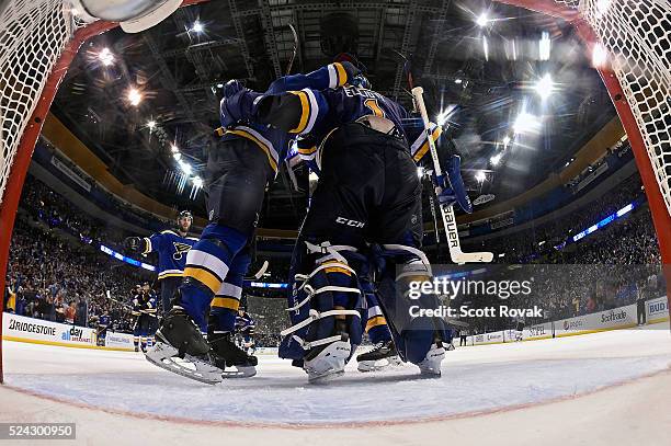 Brian Elliott of the St. Louis Blues is congratulated by teammates after defeating the Chicago Blackhawks 3-2 in Game Seven of the Western Conference...