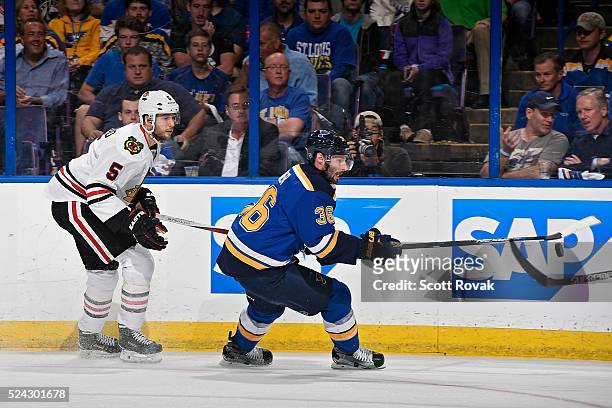 Troy Brouwer of the St. Louis Blues handles the puck as David Rundblad of the Chicago Blackhawks defends in Game Seven of the Western Conference...