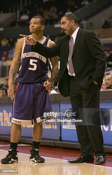 Head coach Lorenzo Romar talks with Will Conroy of the Washington Huskies during the 2005 Pacific Life Pac-10 Men's Basketball Tournament final game...