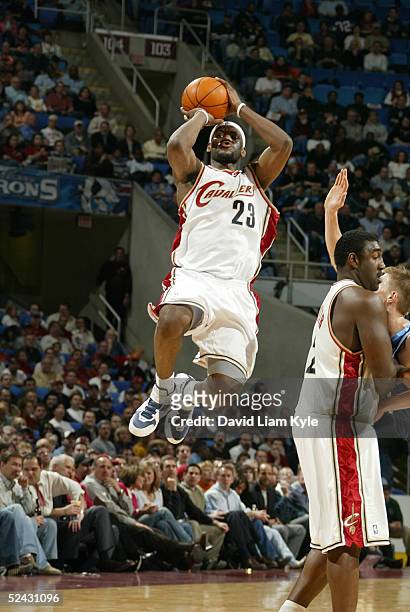 LeBron James of the Cleveland Cavaliers takes a shot against the Utah Jazz on March 15, 2005 at Gund Arena in Cleveland, Ohio. NOTE TO USER: User...