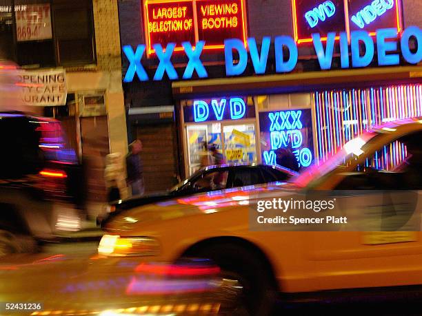 Taxi cabs pass an adult video store in Times Squre March 15, 2005 in New York City. Sex-related shops have started to make a comeback in Times...