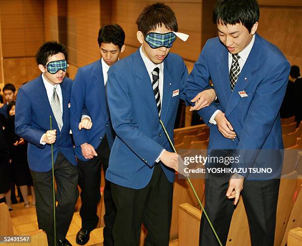 Newly recruited employees of Japanese largest supermarket chain Ito Yokado learn how to guide blind, disabled, or elderly customers during a...