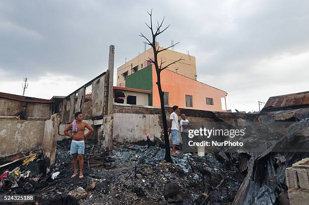 Philippines - Residents scavenge what's left of their house after a fire broke out, Wednesday morning and razed around 60 houses in a neighborhood in...