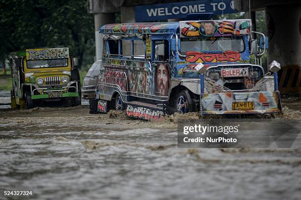 Jeepneys maneuver along a flooded road in Marikina city, east of Manila, Philippines, September 15, 2014. Typhoon Kalmaegi slammed into northern...