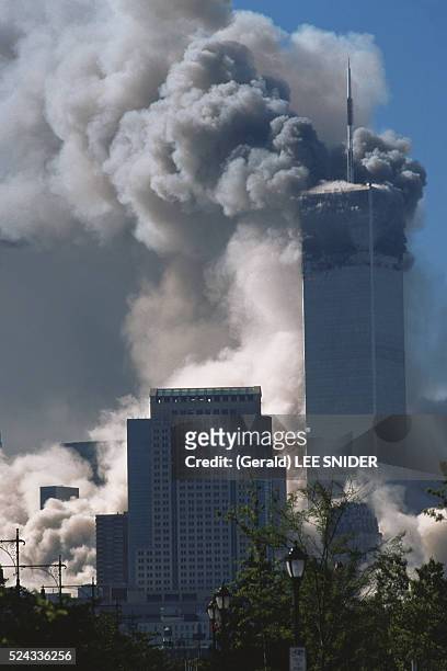 New York: Smoke engulfs neighboring buildings as the South Tower of the World Trade Center collapses, while the North Tower burns, after the...