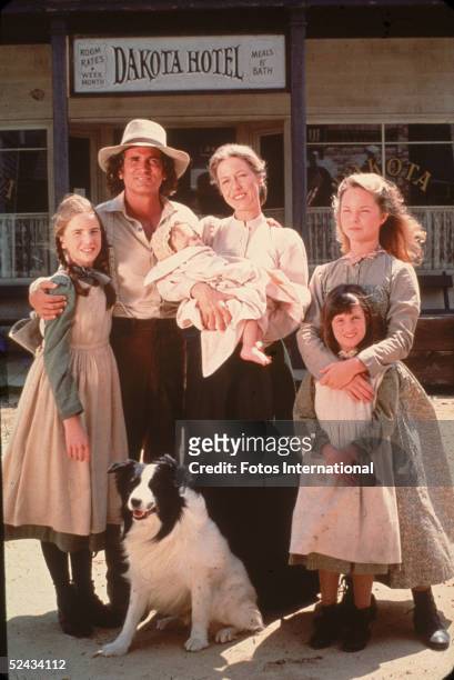 The cast of the television series 'Little House on the Prairie' with a dog on the set of the show, mid 1970s. Clockwise from left: American actors...