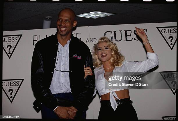 Kareem Abdul-Jabber stands beside Anna Nicole Smith. She has just been announced a Guess? jeans fashion model.