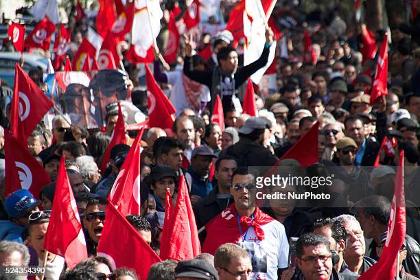 Protestors with path flag and Tunisia flag. On the occasion of the commemoration of the first anniversary of the assassination of Chokri Belaid,...