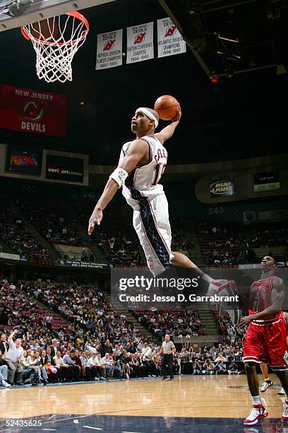 Vince Carter of the New Jersey Nets drives to the hoop past Ben Gordon of the Chicago Bulls on March 16, 2005 at the Continental Airlines Arena in...