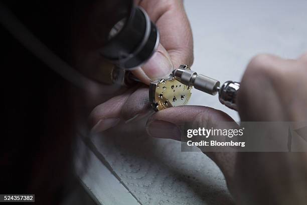 Watchmaker works on a three-quarter plate for a luxury wristwatch inside the A. Lange & Soehne factory, operated by Cie. Financiere Richemont SA, in...