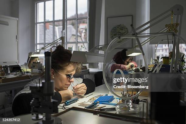 Watchmakers use loupe magnifiers as they work on luxury wristwatch mechanisms inside the A. Lange & Soehne factory, operated by Cie. Financiere...