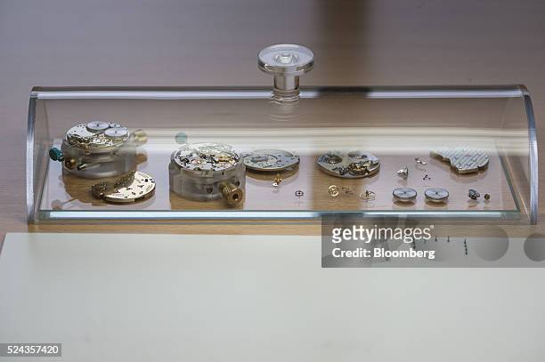 The components of a Lange 1 luxury wristwatch sit in a display case inside the A. Lange & Soehne factory, operated by Cie. Financiere Richemont SA,...