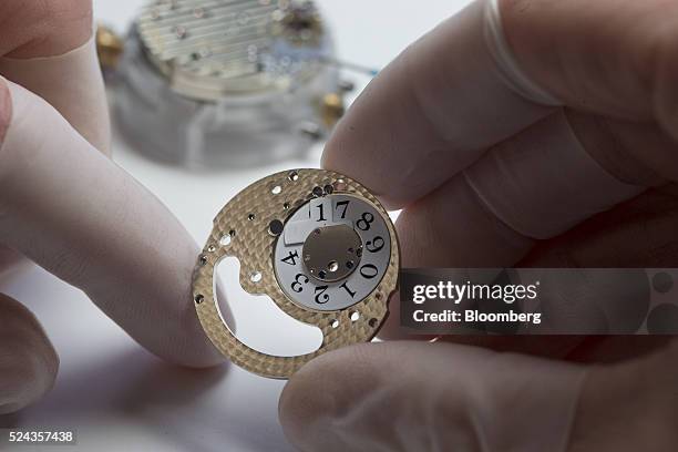 An employee handles the date wheel of a Lange 1 luxury wristwatch during assembly inside the A. Lange & Soehne factory, operated by Cie. Financiere...