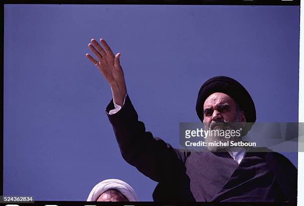 Khomeini returning to Tehran, saluting the crowd from the roof of his house in Qom Qom, Iran.