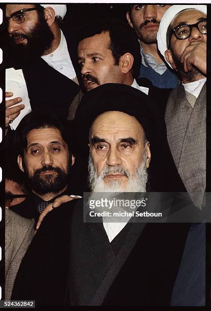 Surrounded by supporters, the Ayatollah Khomeini returns to Tehran from exile.