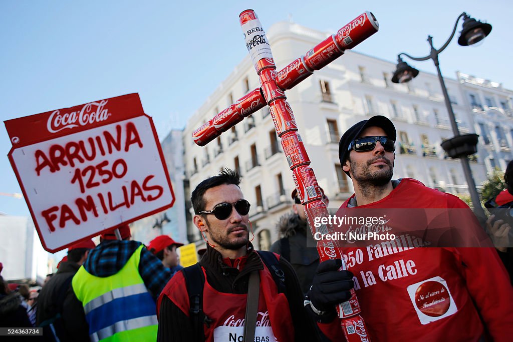 Protesting Coca Cola A protestos holds a crucifix made of coca cola cans while other holds ...