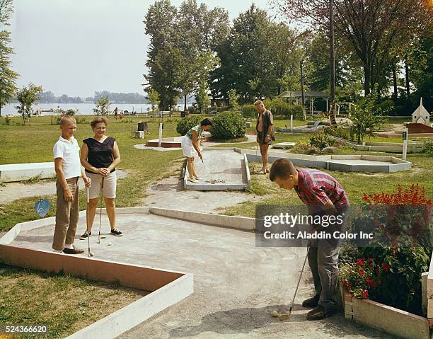 Family plays miniature golf at the Beatley Hotel. | Location: Russells Point, Ohio, USA.