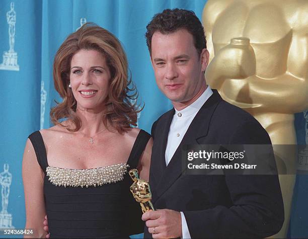 Tom Hanks is joined by his wife, Rita Wilson, at the 1995 Academy Awards ceremony in Los Angeles. Hanks won the Best Actor award for his role in...