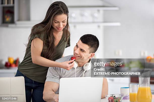 couple in the kitchen - mp3 juices stock pictures, royalty-free photos & images