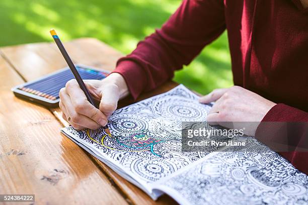 adult woman coloring - kleurboek stockfoto's en -beelden
