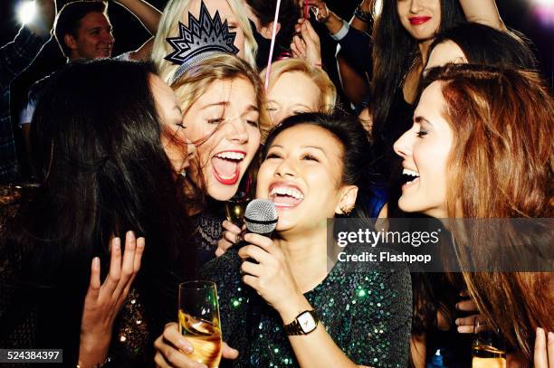 group of friends having fun on night out. karaoke. - girls night stock-fotos und bilder