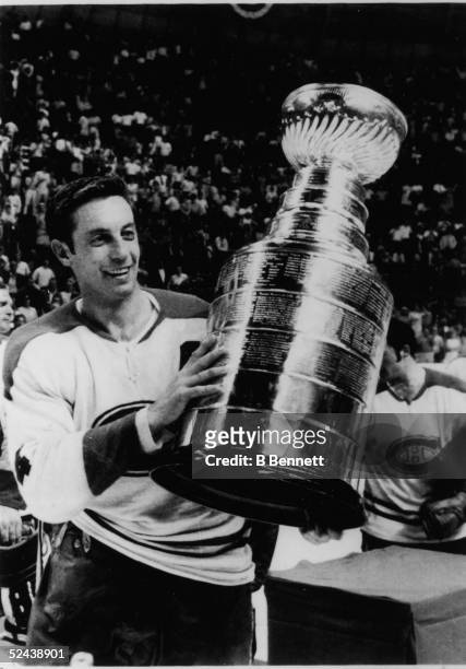Jean Beliveau of the Montreal Canadiens holds up the Stanley Cup Trophy after defeating the St. Louis Blues in Game 4 of the 1969 Stanley Cup Finals...