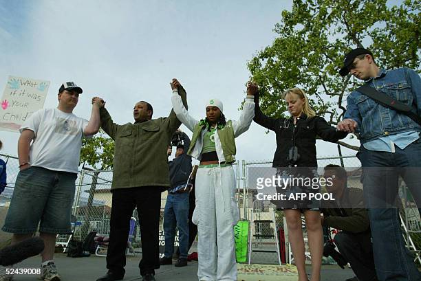 Small group of Michael Jackson fans hold a prayer vigil outside Santa Barbara County Courthouse in Santa Maria, California, 17 March 2005 before the...