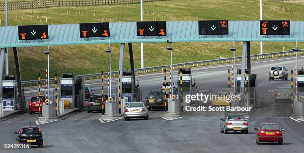 Vehicles aproach the M6 motorway toll booths on March 13, 2005 in Birmingham, England. The number of vehicles using the Toll road which opened in...