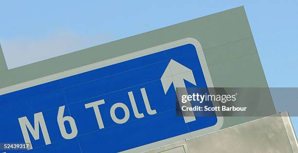 Toll sign hangs above the road as vehicles approach the M6 motorway toll booths on March 13, 2005 in Birmingham, England. The number of vehicles...