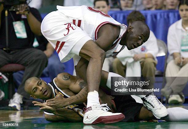 Jean Felix of the Alabama Crimson Tide ties up Ed McCants of the Milwaukee-Wisconsin Panthers as he tries to call time out during the first round of...