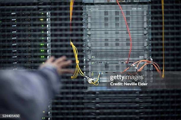 Elios Astudillo, sales Engineer points out a server inside Index Exchange's cage at Equinix's Data transfer center in New Jersey. High speed data...