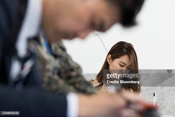 Jobseekers fill out application forms at a job fair in Goyang, South Korea, on Tuesday, April 26, 2016. South Korea's economy slowed in the first...