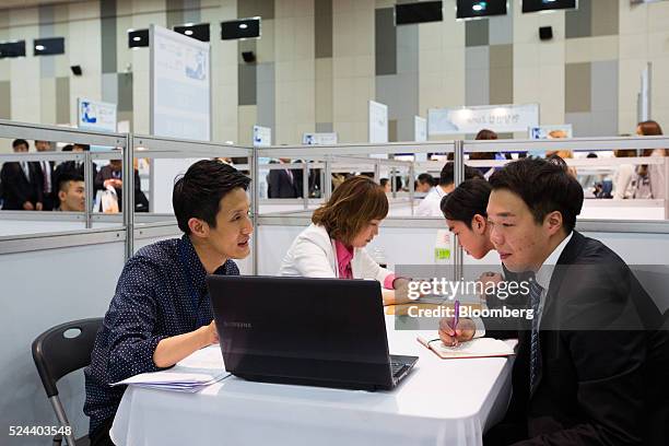 Jobseekers speak with recruitment representatives at a job fair in Goyang, South Korea, on Tuesday, April 26, 2016. South Korea's economy slowed in...
