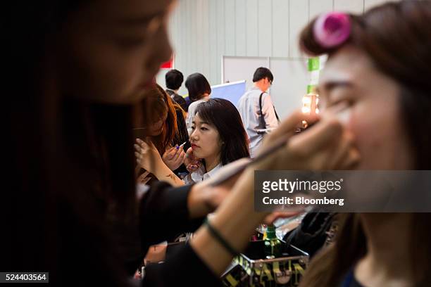 Jobseeker has makeup applied at a job fair in Goyang, South Korea, on Tuesday, April 26, 2016. South Korea's economy slowed in the first quarter as...