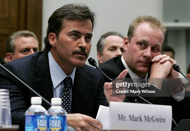 Baltimore Oriole Rafael Palmeiro testifies as Boston Red Sox pitcher Curt Schilling listens during a House Committe session investigating Major...