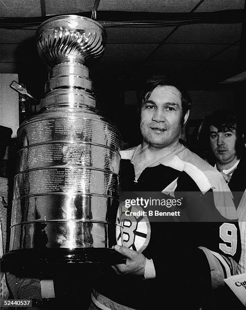 Johnny Bucyk of the Boston Bruins holds the Stanley Cup after Game 6 of the 1972 Stanley Cup Finals against the New York Rangers on May 11, 1972 at...