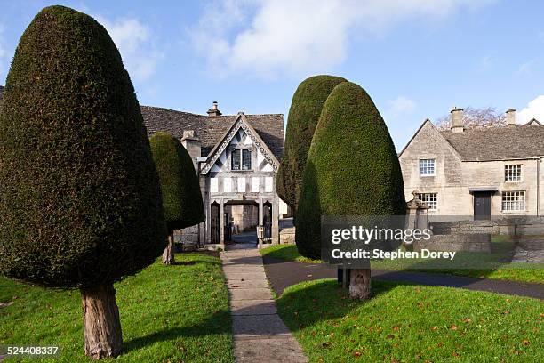 the lych gate and yew trees at painswick - yew tree stock pictures, royalty-free photos & images