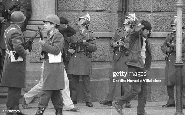 Group of Allendes bodyguards are held prisoners by Carabineros, across the street from La Moneda. All of them were killed later. Photographed in the...