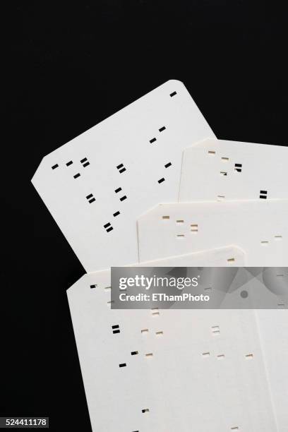 early computer punch card (circa 1970) - holes the book stock pictures, royalty-free photos & images