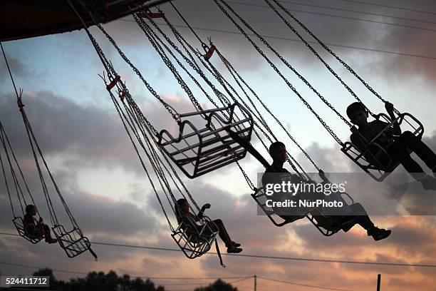 Palestinians have in the second day of the Eid al-Fitr holiday in a park in Gaza City, on August 9, 2013. Photo: Majdi Fathi/NurPhoto